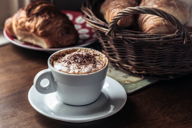 Coffee and pastries on wooden table